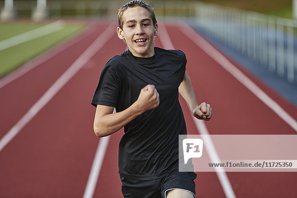 Teenage boy running in sports track