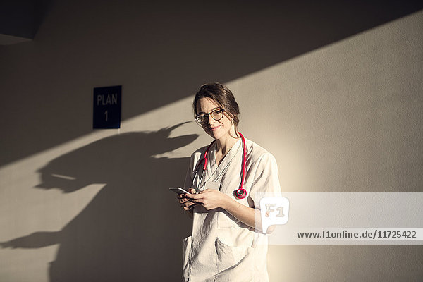 Female doctor using smartphone