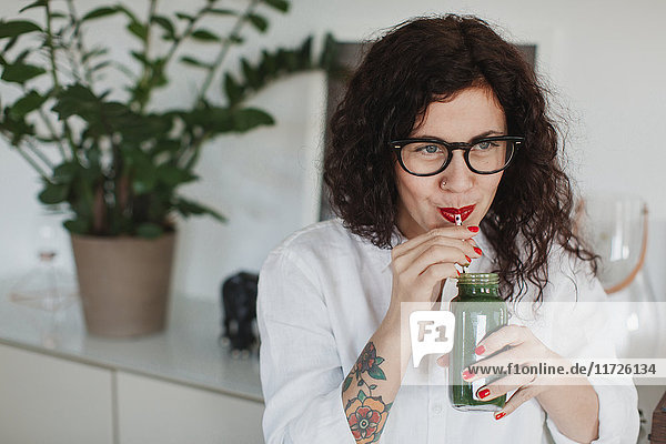Young woman drinking smoothie