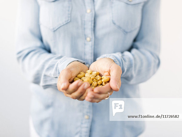 Woman holding handful of nuts