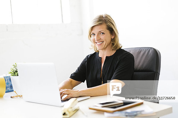 Portrait of Mature woman working on laptop