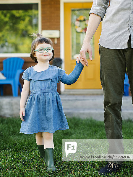 Daughter (2-3) walking with father