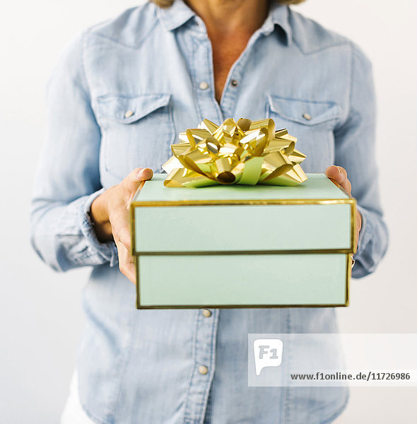 Mid section of Mature woman holding gift