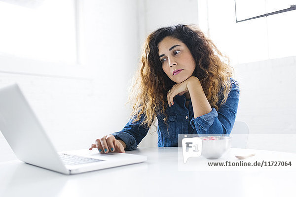 Portrait of mid adult woman using laptop