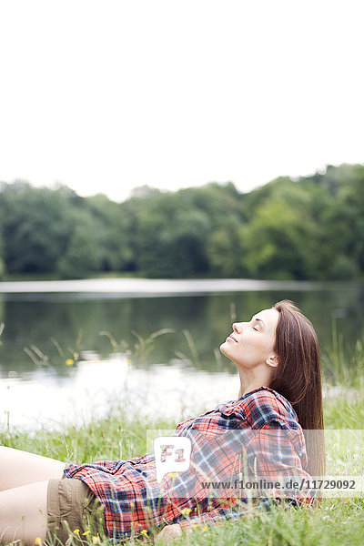 Woman relaxing by a lake