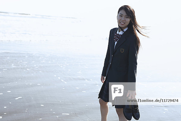 Young Japanese woman in a high school uniform by the sea  Chiba  Japan