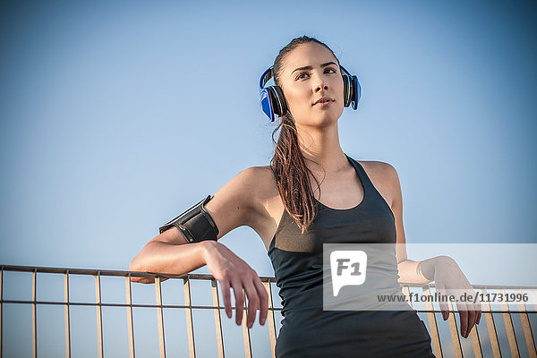Young woman wearing headphones resting