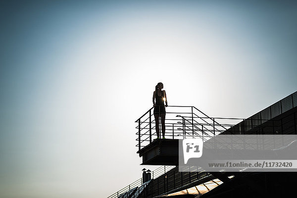 Woman standing on high platform  low angle