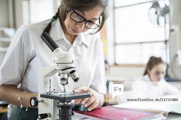 Student using microscope in lab