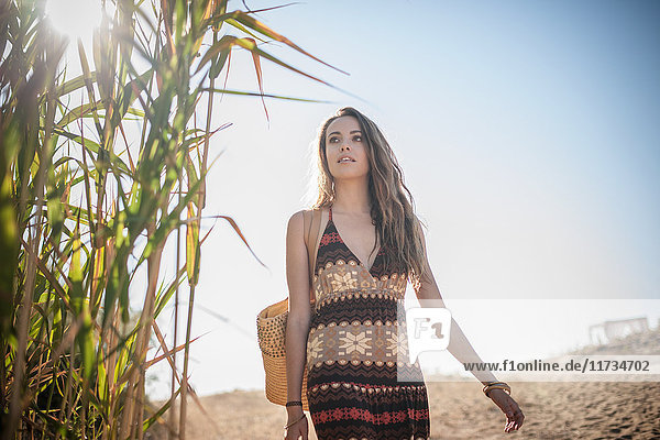 Beautiful young woman strolling on beach  Castiadas  Sardinia  Italy
