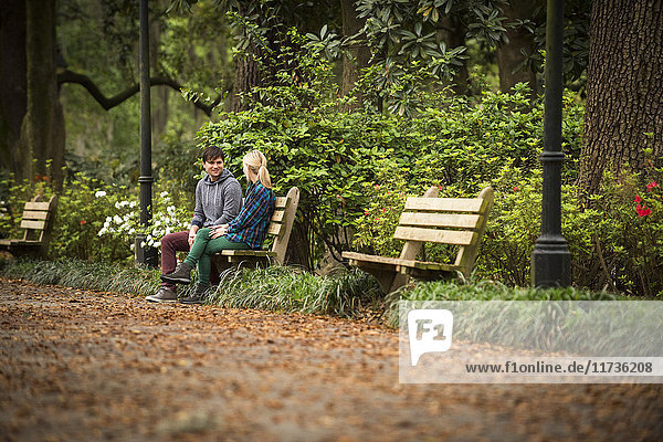 Couple chatting on park bench  Savannah  Georgia  USA