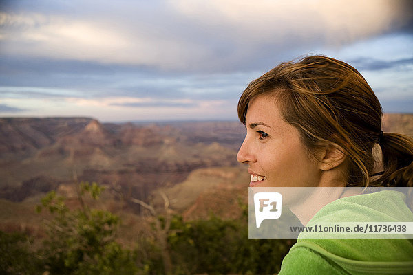 Portrait of female tourist looking out over Grand Canyon  Arizona  USA