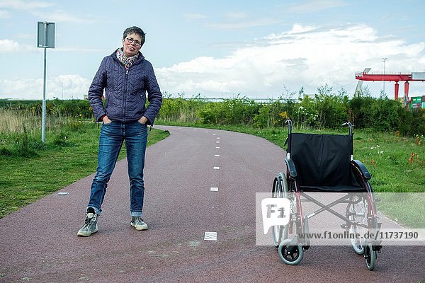 Tilburg  Netherlands. Female multiple sclerosis patient dealing with her condition by on and off using a wheelchair to get along.