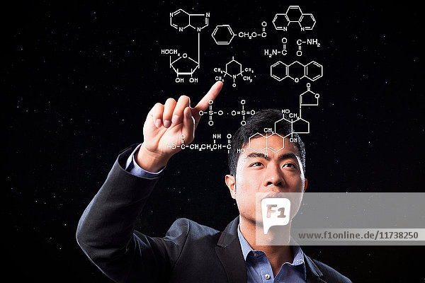 Businessman pointing at scientific diagram