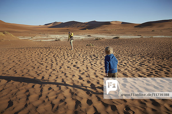 Boy walking in desert  Namib Naukluft National Park  Namib Desert  Sossusvlei  Dead Vlei  Africa