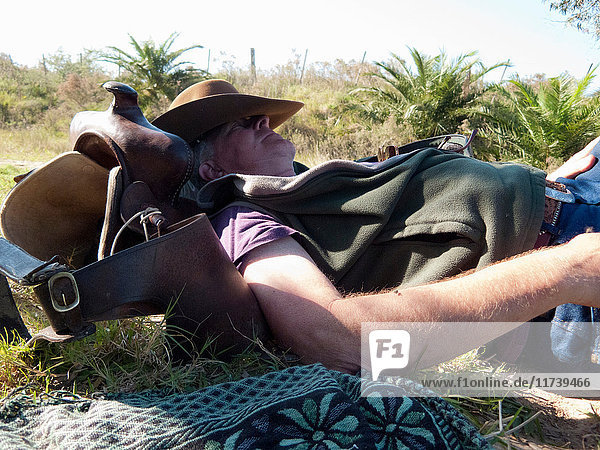 Senior man lying on back resting on saddle  Uruguay