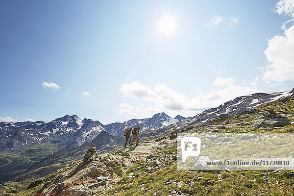 Young couple hiking up Val Senales Glacier  Val Senales  South Tyrol  Italy
