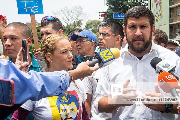 Lilian Tintori,  wife of political leader Leopoldo Lopez,  and Mayor David Smolansky giving statements to the press. The opposition mobilization called 'Great March for Health and Life' was developed in Avenida Francisco de Miranda,  and could not reach the Ministry of Health,  as it was suppressed by the police and national guard. May,  22,  2017. Caracas,  Venezuela.