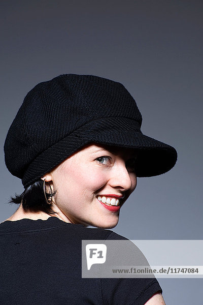 Young woman in black hat smiling  portrait
