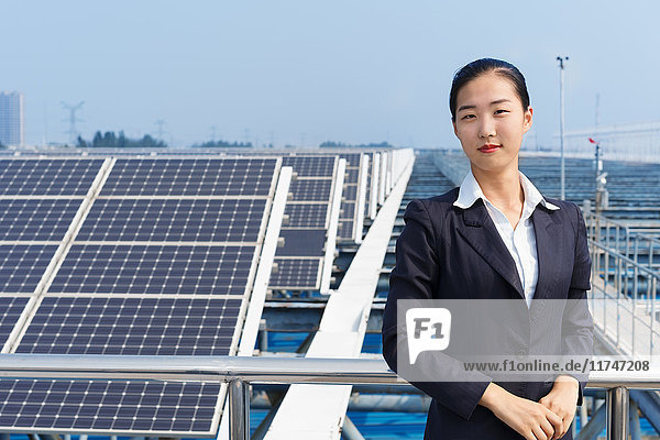Businesswoman on roof of solar panel assembly factory  Solar Valley  Dezhou  China