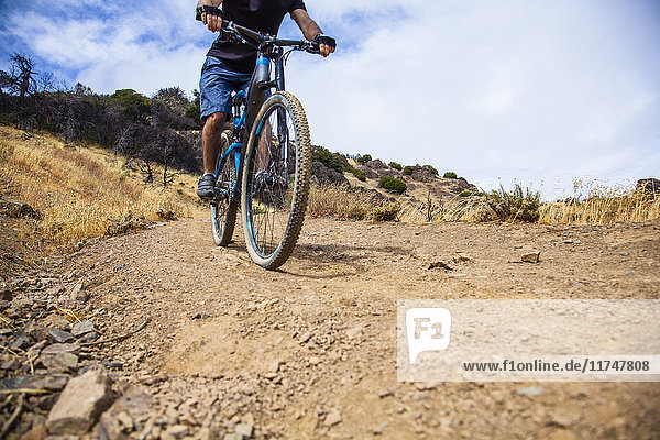 Cropped shot of young man mountain biking on dirt track  Mount Diablo  Bay Area  California  USA
