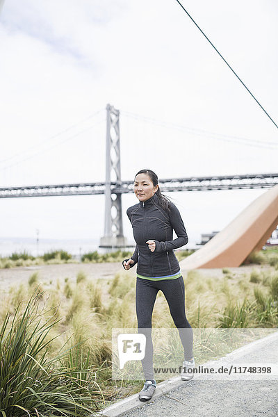 Female runner  Bay Bridge in background  San Francisco  California