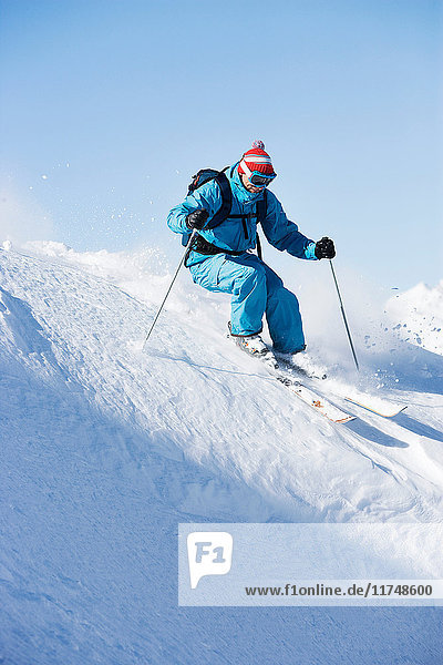 Male skiing downhill at speed