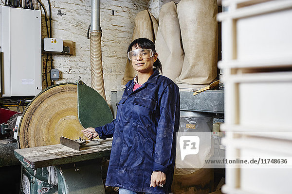 Portrait einer Druckerin mit Kreissäge in einer traditionellen Druckwerkstatt