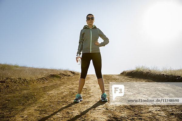 Portrait of female runner on dirt track