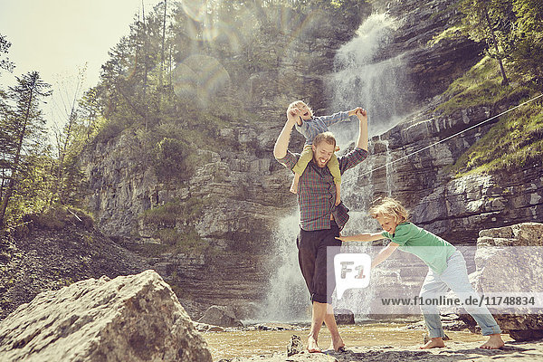 Two generation family having fun by waterfall  Ehrwald  Tyrol  Austria