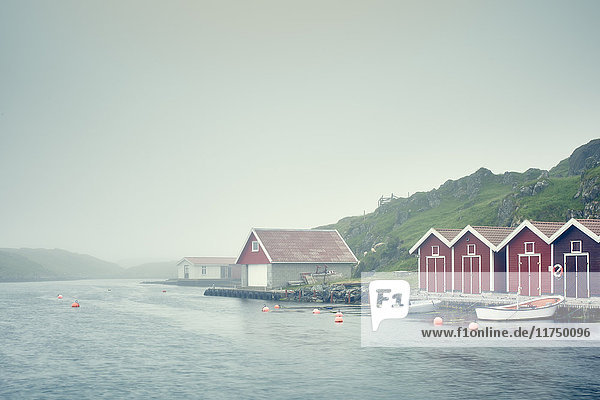 Farbenfrohe Bootshäuser und festgemachte Boote am Wasser Haugesund Kreis Rogaland Norwegen