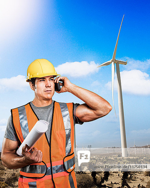 Man standing in front of wind farm