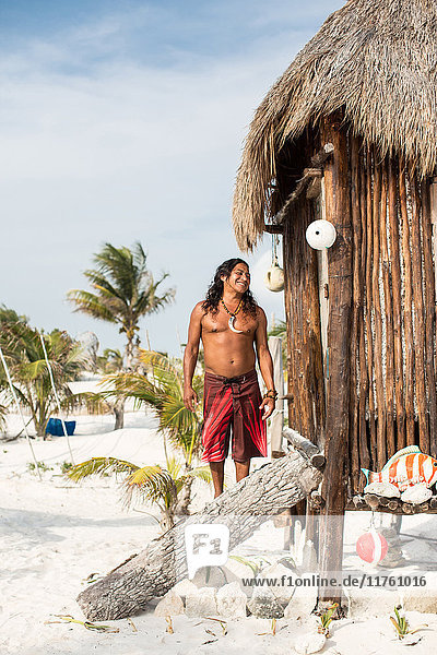 Portrait of mature man beside beach hut  Tulum  Mexico