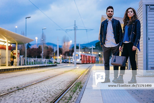 Couple waiting on tramway platform  Florence  Italy
