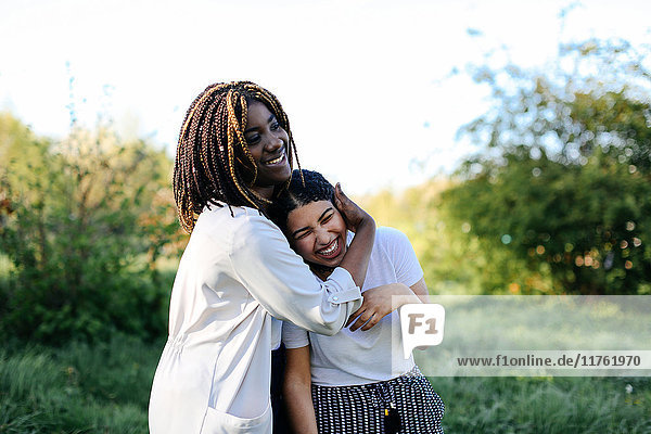 Two teenage girls  fooling around  hugging  laughing