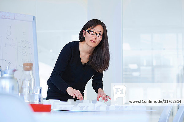 Portrait of businesswoman in architect office looking at camera