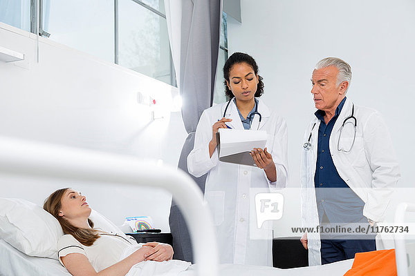 Doctors consulting with patient