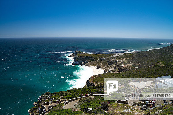 View back to the Cape Peninsula  with tourists walkning down from the lighthouse at Cape Point  near Cape Town  South Africa  Africa