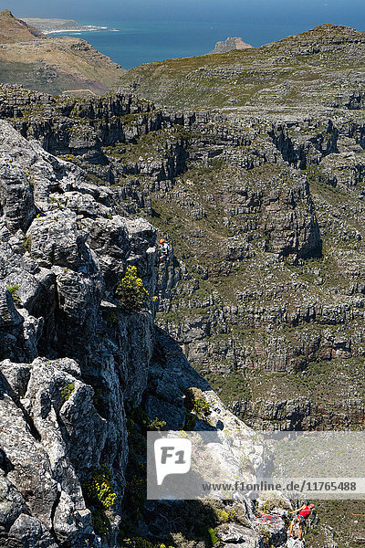 Two climbers descending from the top of Table Mountain  Cape Town  South Africa  Africa