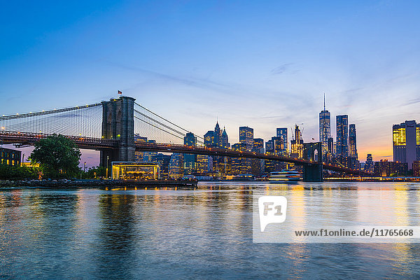 Brooklyn Bridge and Manhattan skyline at dusk  viewed from the East River  New York City  United States of America  North America