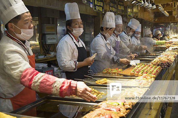 Chefs in food centre  Lijiang  UNESCO World Heritage Site  Yunnan  China  Asia