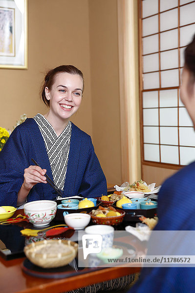 Caucasian woman wearing yukata eating at traditional ryokan  Tokyo  Japan