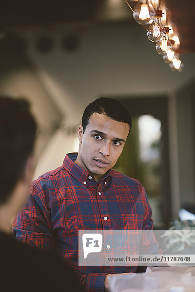 Businessman looking at colleague in meeting