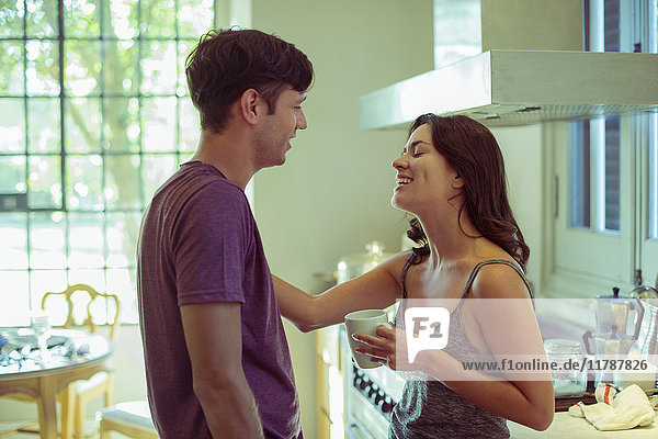 Couple chatting in kitchen