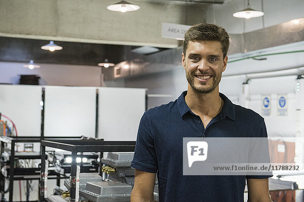 Man smiling in factory  portrait