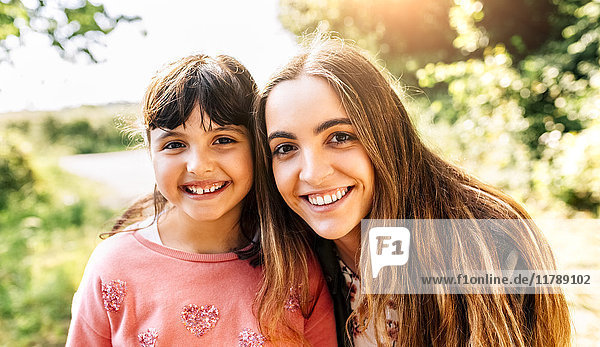 Portrait of two smiling girls outdoors