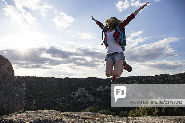 Spain  Madrid  young woman jumping during a trekking day