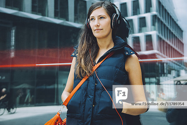 Young woman with headphones in the city