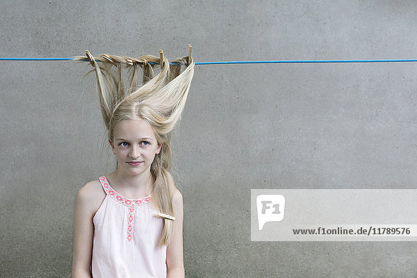 Blond girl's hair drying on clothesline