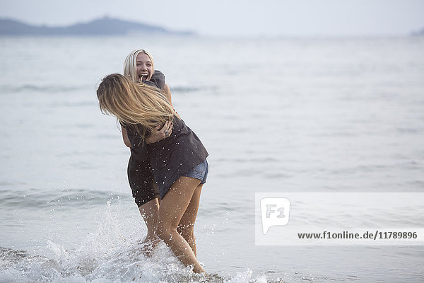 Two young women having fun in the sea